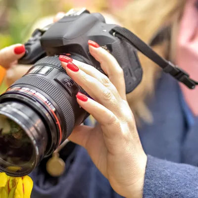 A Young Woman Takes A Photo On Camera Of Tulips In 2026 03 20 02 10 27 Utc