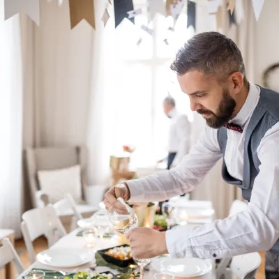 Man Preparing Table Setting For An Indoor Celebrat 2026 03 10 03 56 24 Utc